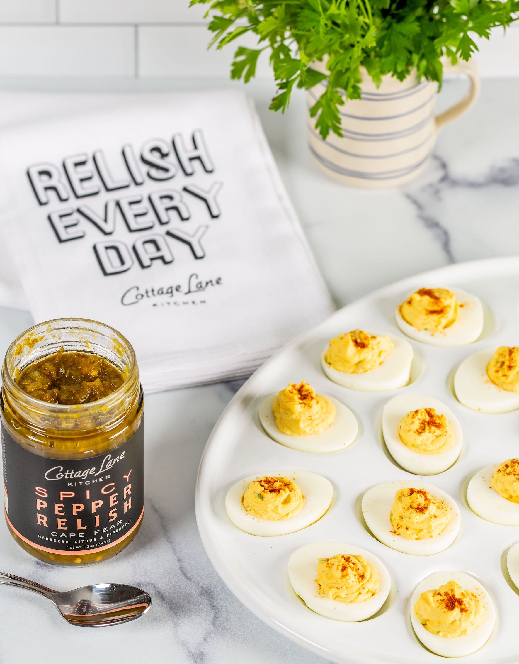 Cape Fear Spicy Pepper Relish on Devilled Eggs with Towel that is printed with Relish every Day Cottage Lane Kitchen on it