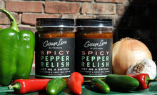Two bottles of Get Me A Switch Spicy Pepper Relish with fresh ingredients